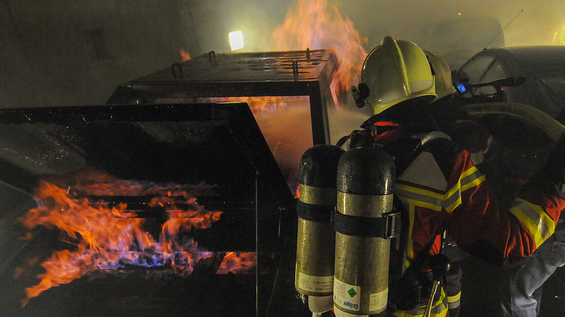 Drill with gas fires Firefighters during a drill with a burning mock-up car in the tunnel